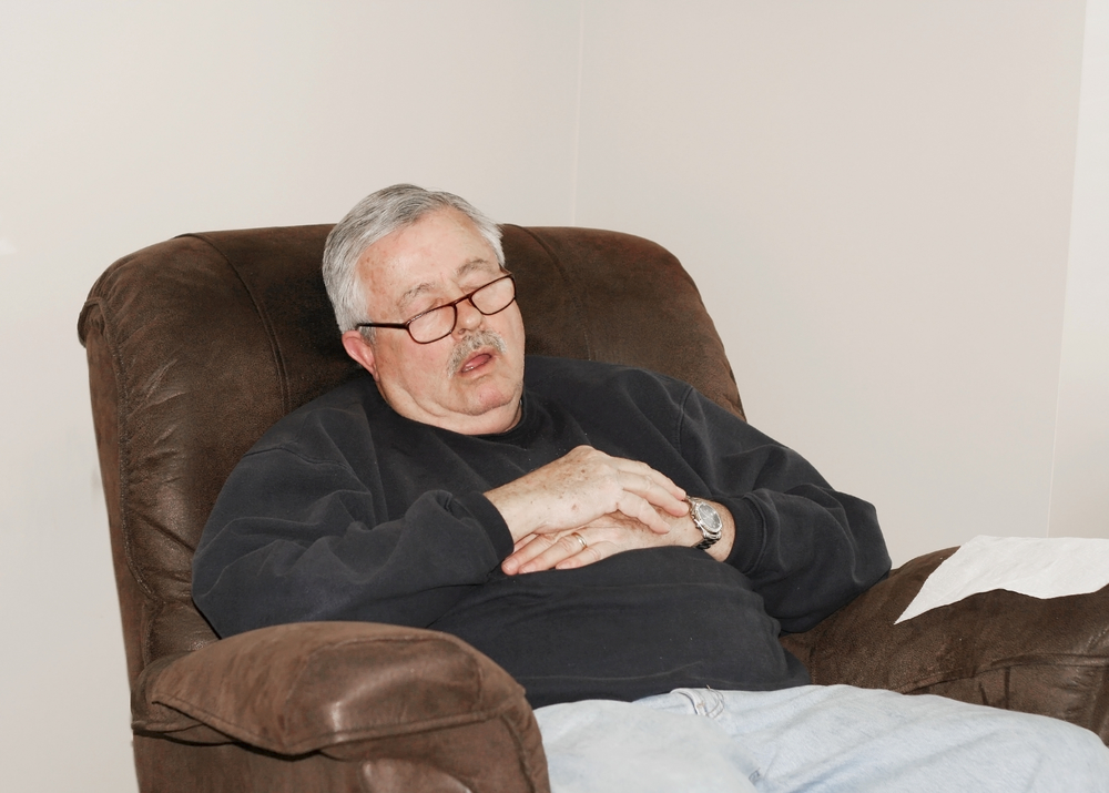 man sleeping in recliner chair